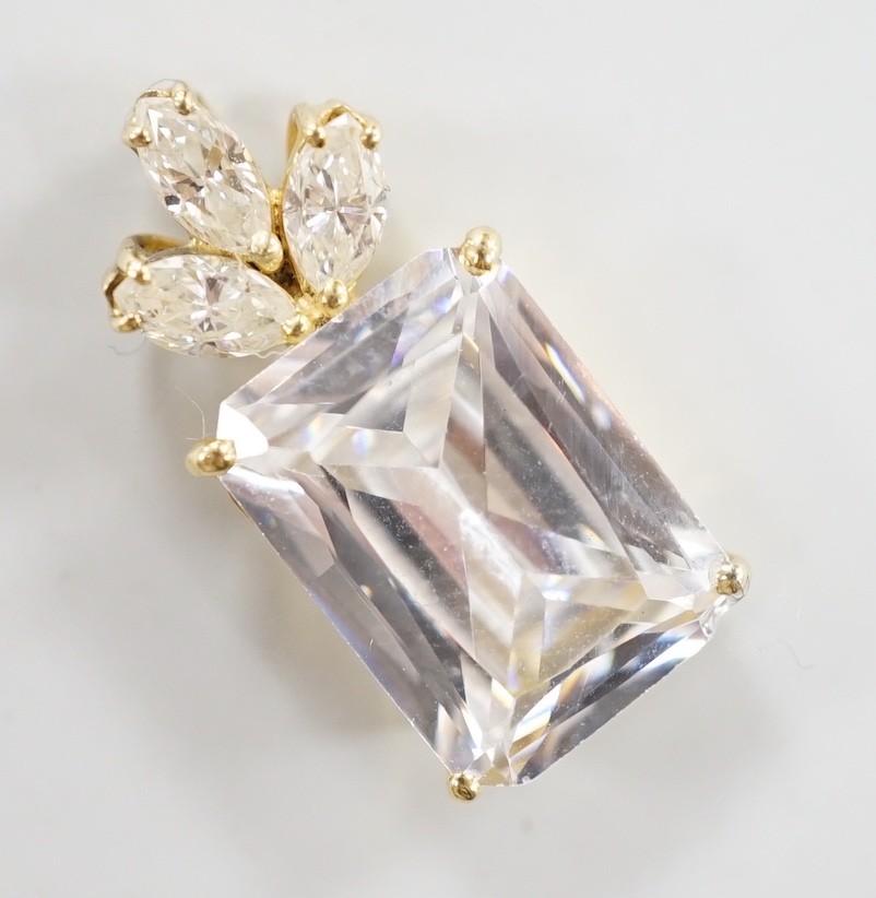 A modern yellow metal mount single stone simulated diamond and three stone diamond set pendant, 21mm, gross weight 4.2 grams.